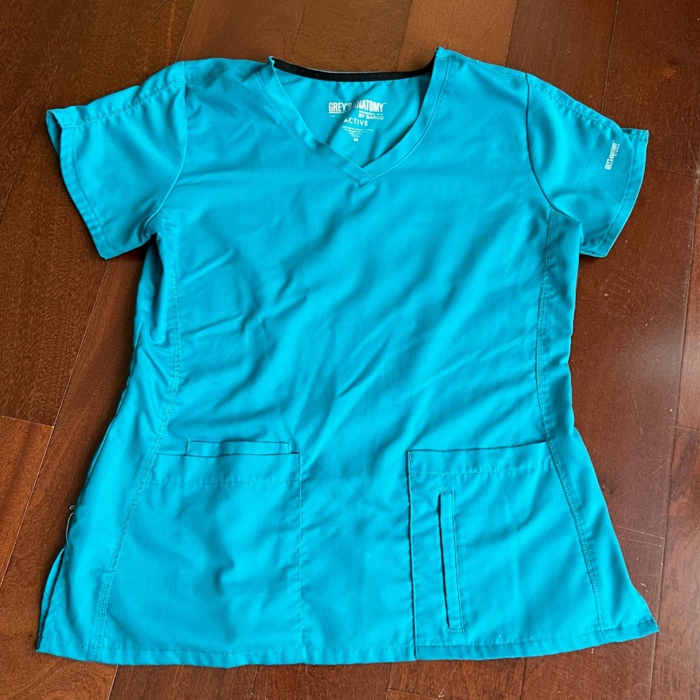Grey’s Anatomy Active Scrub Top, Size Medium, Color is Teal